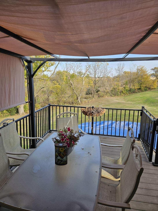 deck featuring a yard and a pergola