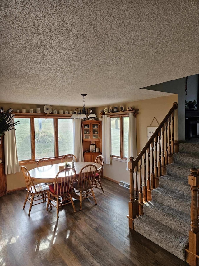 dining room featuring dark wood-type flooring and an inviting chandelier