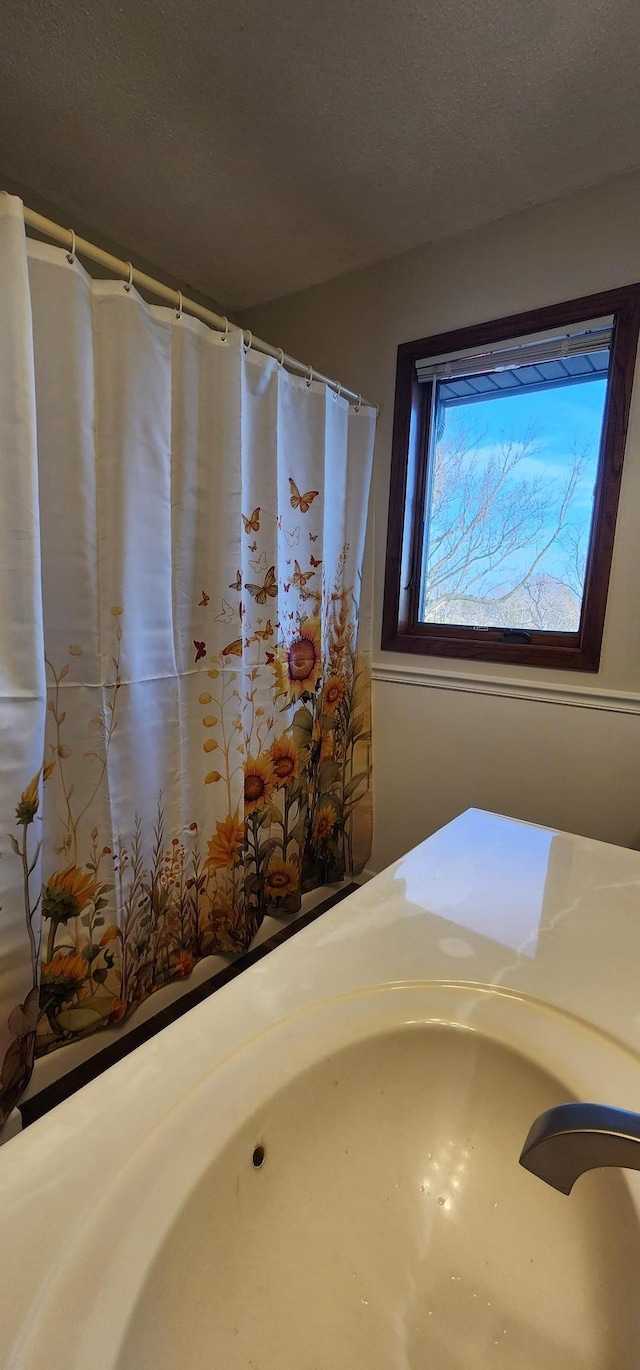 bathroom featuring a textured ceiling and sink