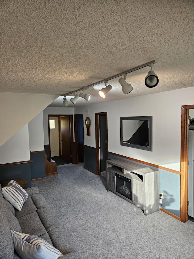 carpeted living room with a textured ceiling