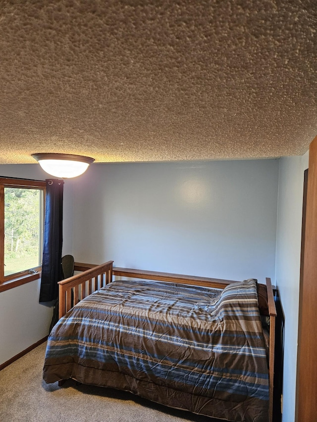 carpeted bedroom featuring a textured ceiling