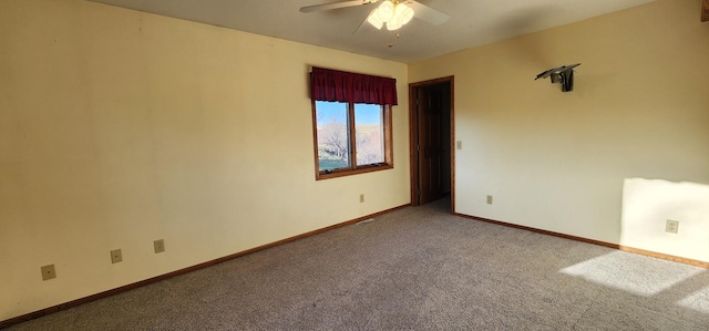 spare room featuring ceiling fan and carpet flooring