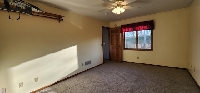 empty room with ceiling fan and carpet