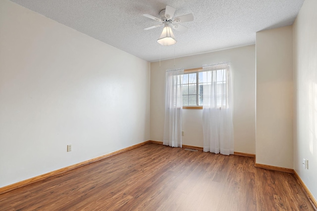 spare room with a textured ceiling, hardwood / wood-style flooring, and ceiling fan