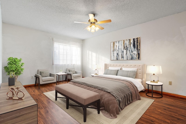 bedroom with ceiling fan, dark hardwood / wood-style floors, and a textured ceiling