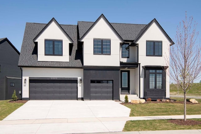 view of front of home with a front yard and a garage