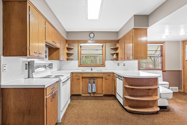 kitchen featuring backsplash, kitchen peninsula, sink, and white appliances