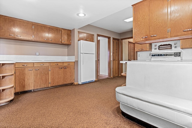 kitchen featuring carpet flooring and white fridge