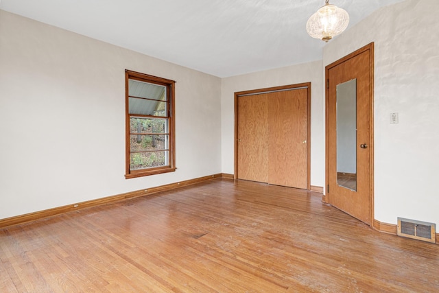 empty room with wood-type flooring