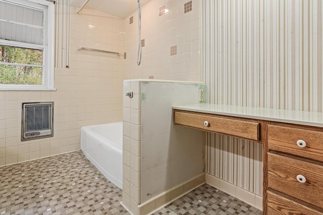 bathroom with plus walk in shower, heating unit, and tile walls