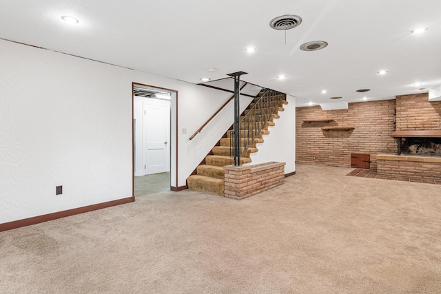 basement featuring light carpet and a fireplace