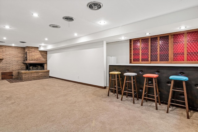 bar featuring carpet and a brick fireplace