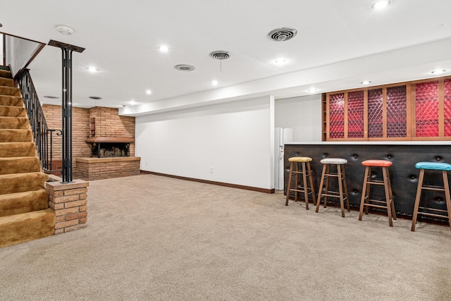 bar with a fireplace and carpet floors