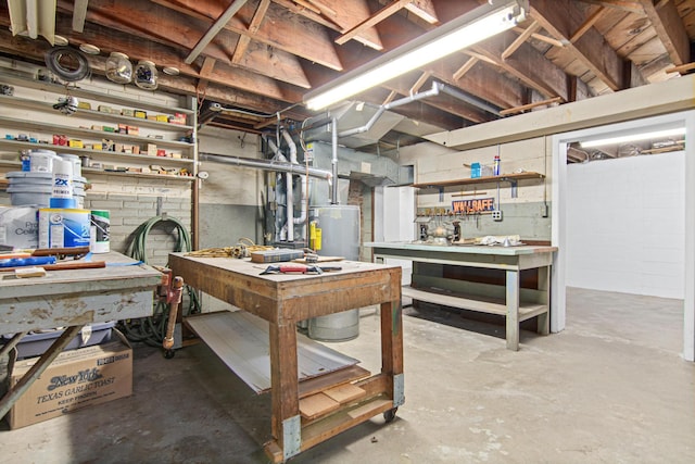 basement featuring a workshop area and water heater