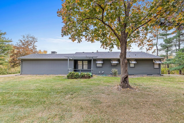 rear view of house with a lawn