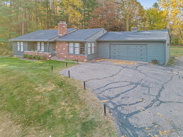 single story home with a front lawn and a garage