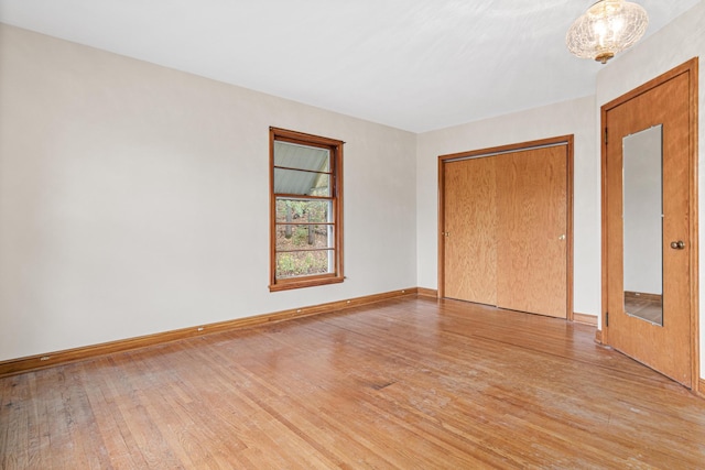 unfurnished bedroom with a closet and light hardwood / wood-style flooring