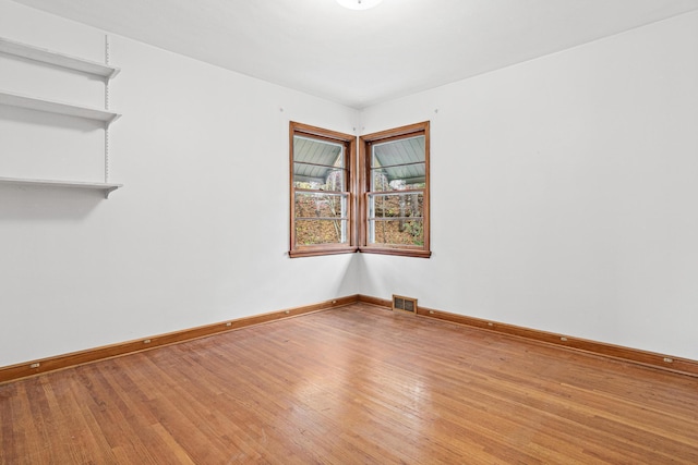 unfurnished room with wood-type flooring