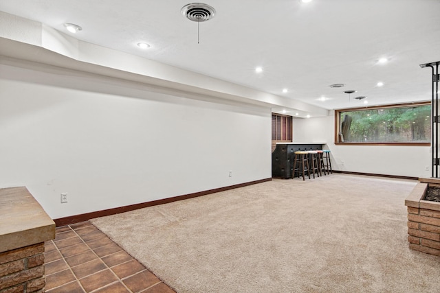 basement featuring dark carpet