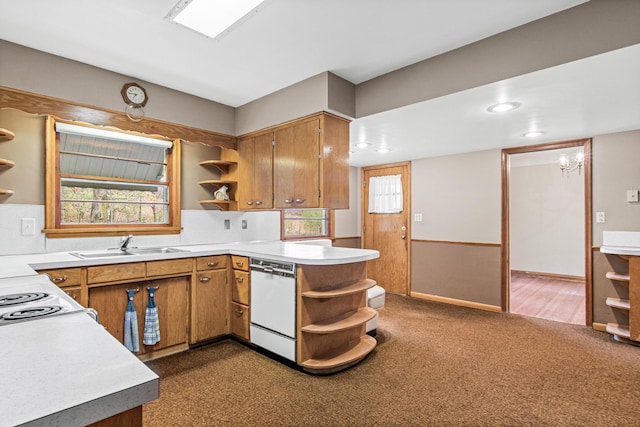 kitchen featuring kitchen peninsula, dishwasher, sink, and dark colored carpet