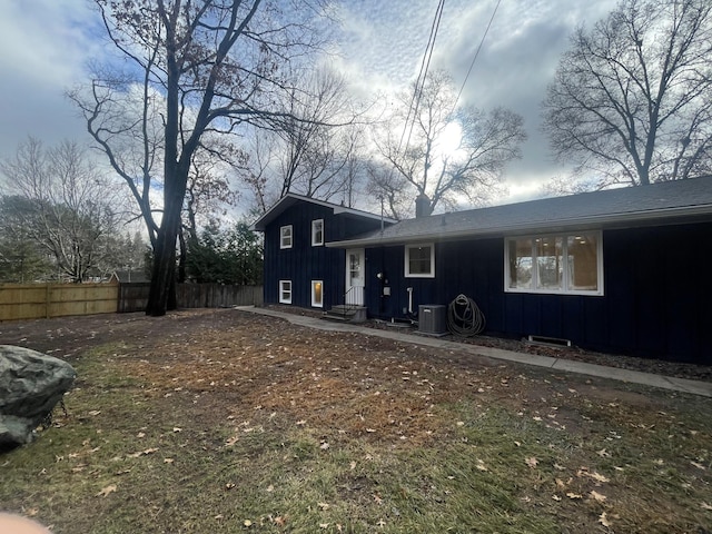 exterior space featuring fence and central AC unit