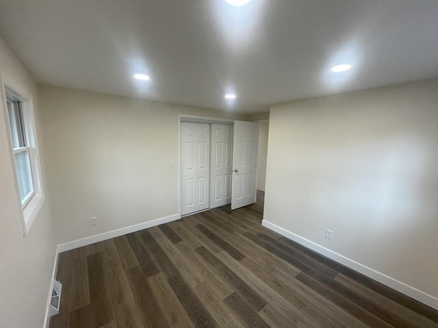 interior space with recessed lighting, dark wood-style flooring, visible vents, and baseboards