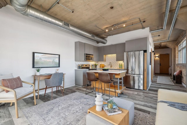 living room featuring light wood-type flooring and sink