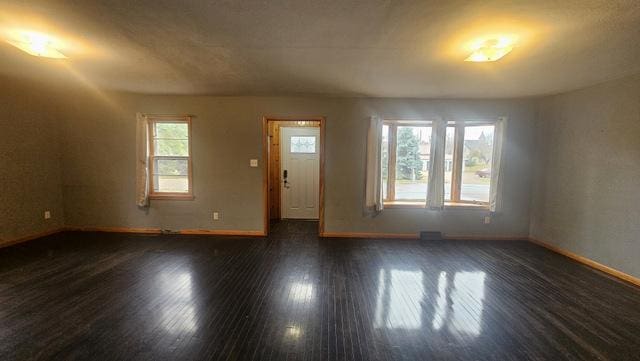 spare room featuring dark wood-type flooring