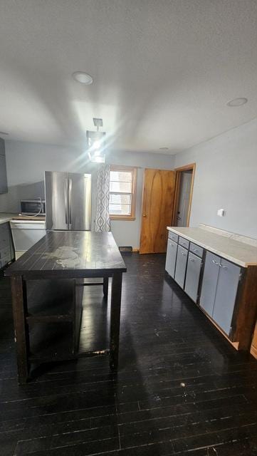 unfurnished dining area with dark wood-type flooring