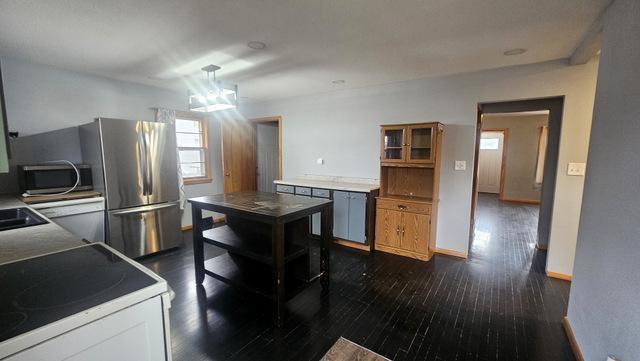 kitchen with dark wood-type flooring and range with electric cooktop