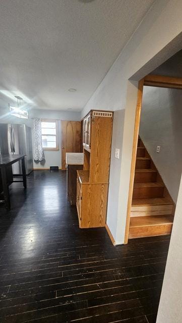 kitchen featuring a textured ceiling, dark hardwood / wood-style floors, and stainless steel fridge