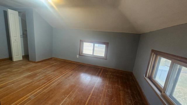 bonus room featuring hardwood / wood-style floors and vaulted ceiling