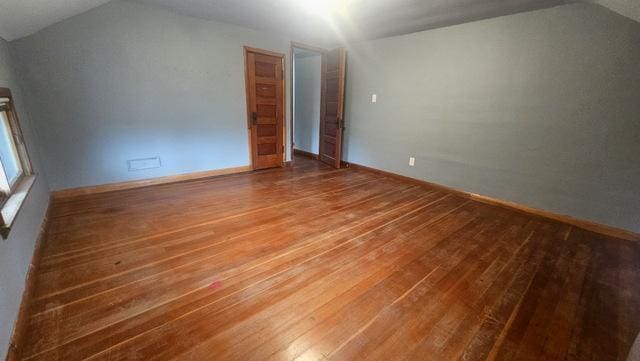 bonus room featuring hardwood / wood-style floors and vaulted ceiling