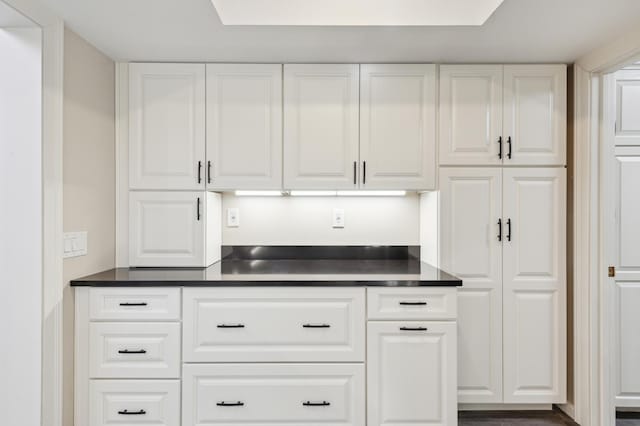 bar featuring white cabinetry