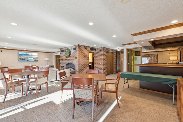 carpeted dining area featuring ornamental molding and a fireplace