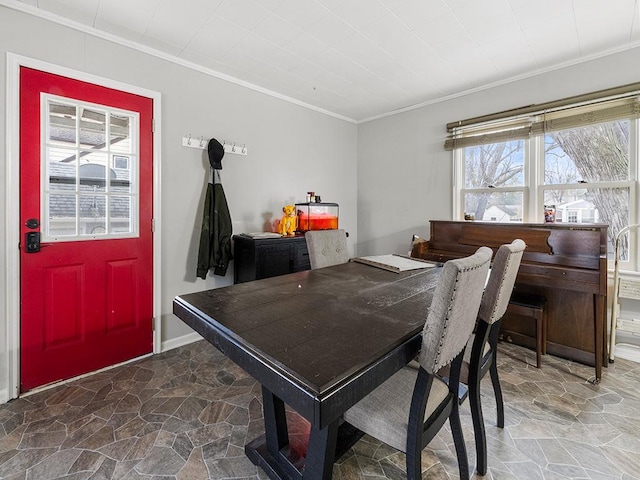 dining space with crown molding