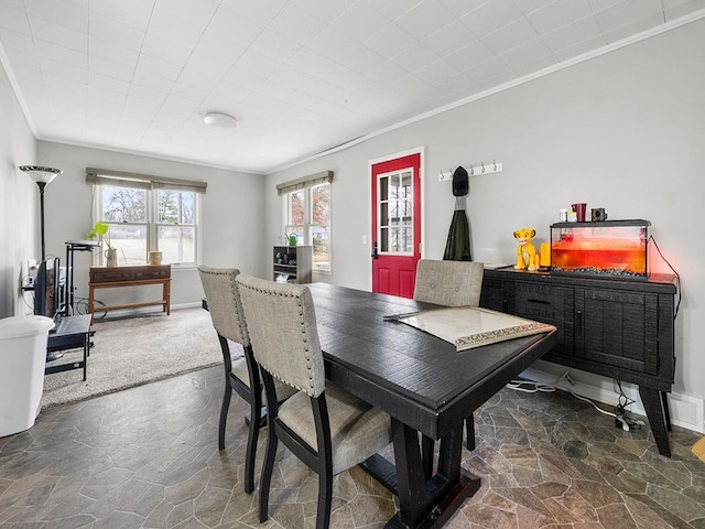 carpeted dining area featuring ornamental molding