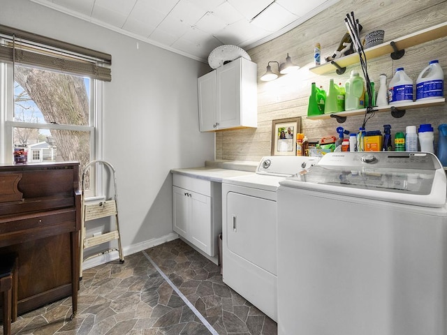 laundry area featuring separate washer and dryer, wood walls, cabinets, and ornamental molding