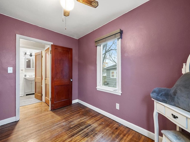 bedroom featuring ceiling fan, hardwood / wood-style floors, and ensuite bathroom