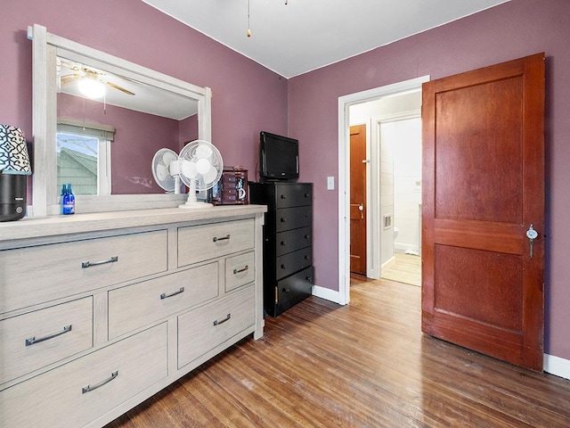 bedroom with dark hardwood / wood-style flooring