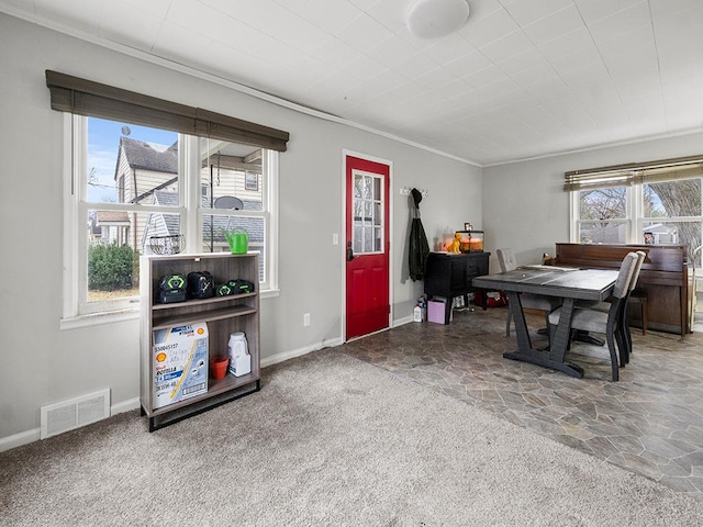 dining space with carpet flooring and ornamental molding