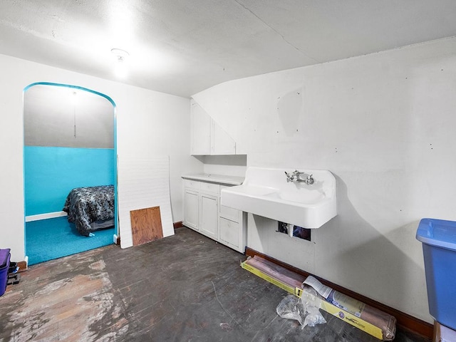 bathroom featuring sink and vaulted ceiling