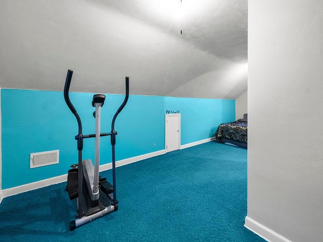 workout room featuring dark carpet and vaulted ceiling