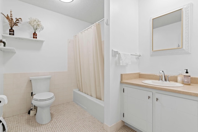 full bathroom featuring toilet, tile walls, a textured ceiling, and tile patterned flooring