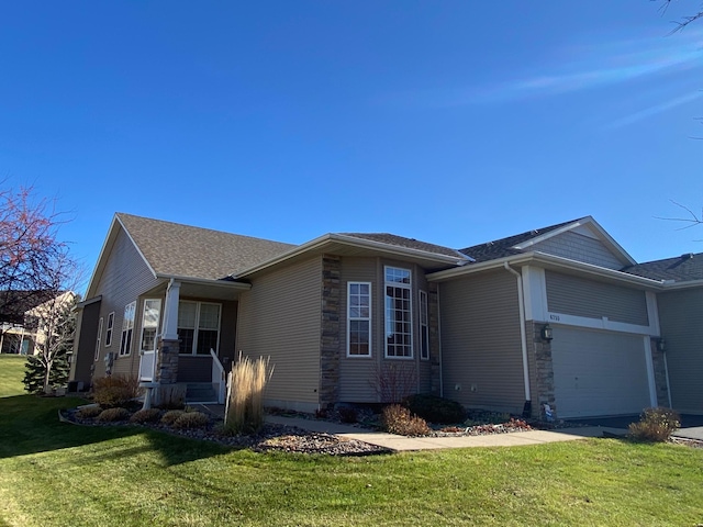 view of front of house featuring a garage and a front lawn