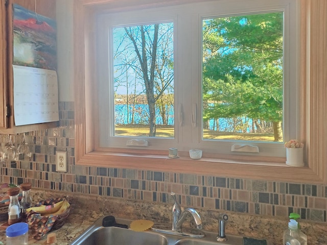 interior details featuring sink and stone countertops