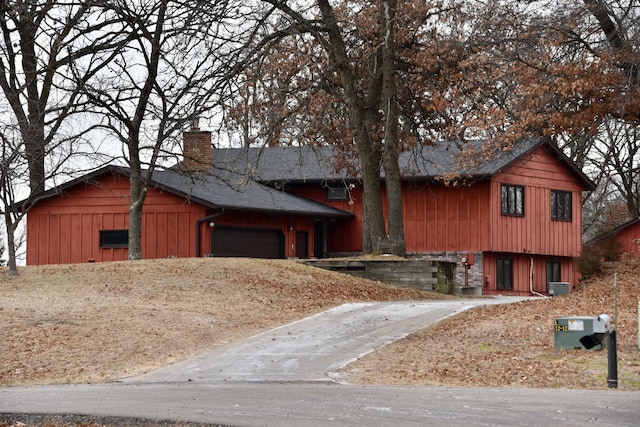 view of front of house with central AC and a garage