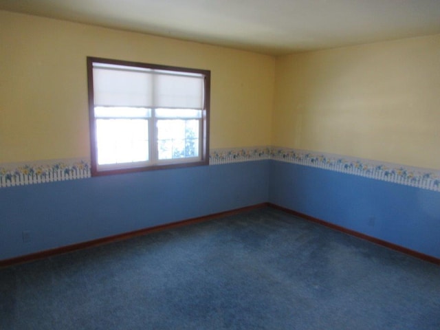 unfurnished room featuring dark carpet