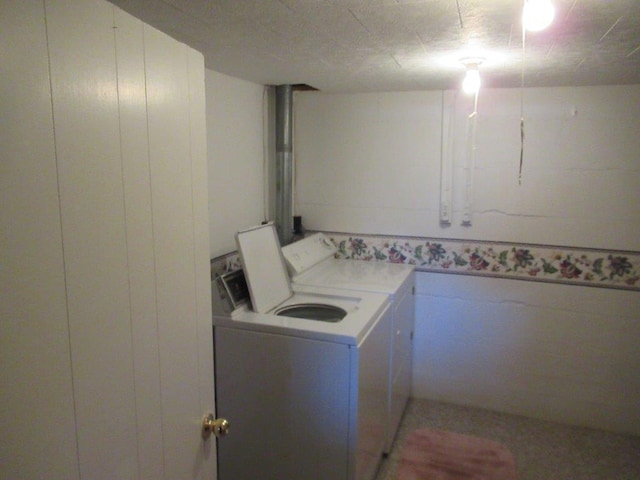 clothes washing area featuring separate washer and dryer