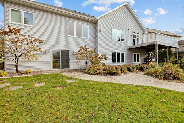 back of house with a yard and a deck